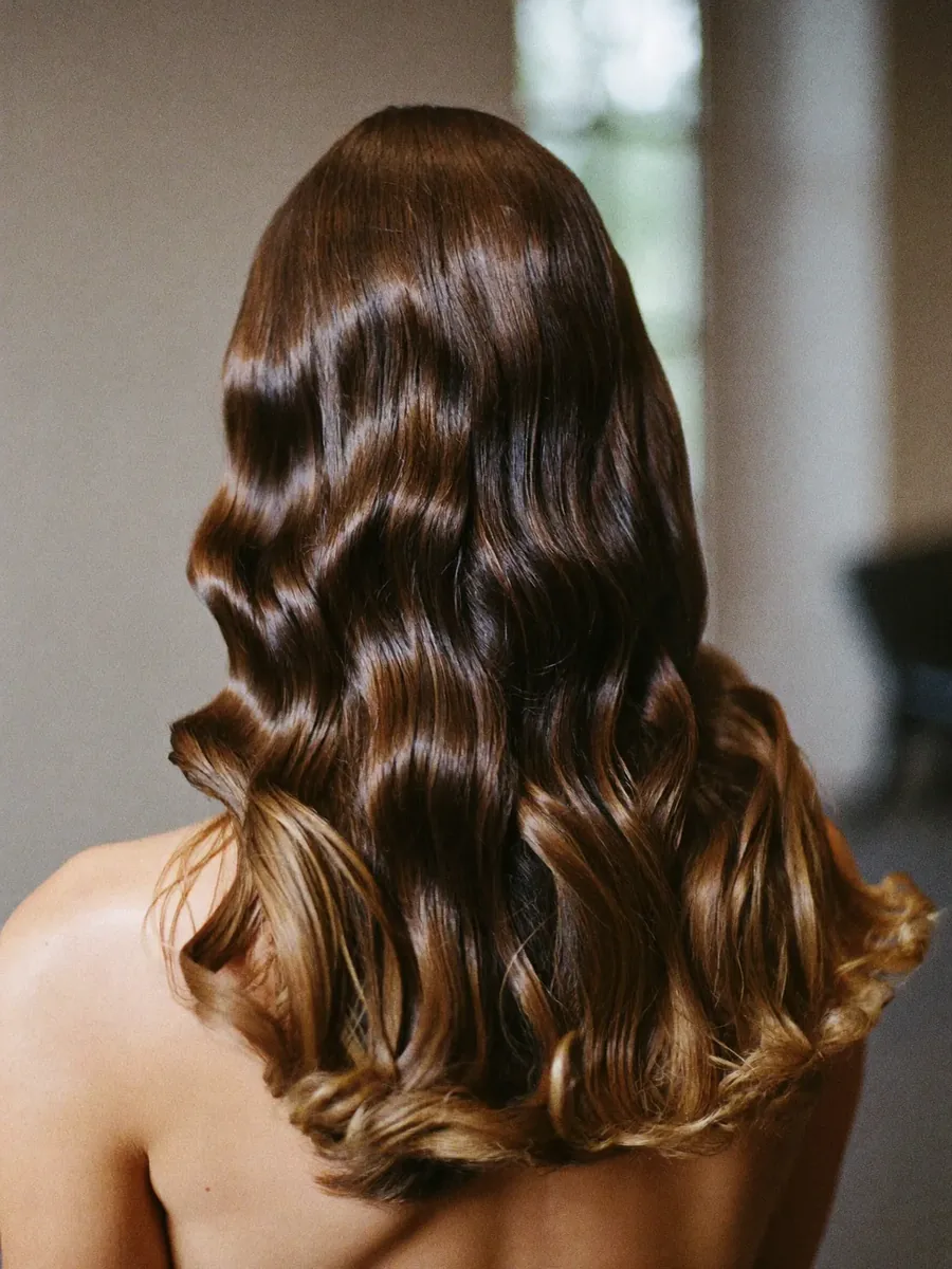 A finished blow-dry with loose waves, seen from behind